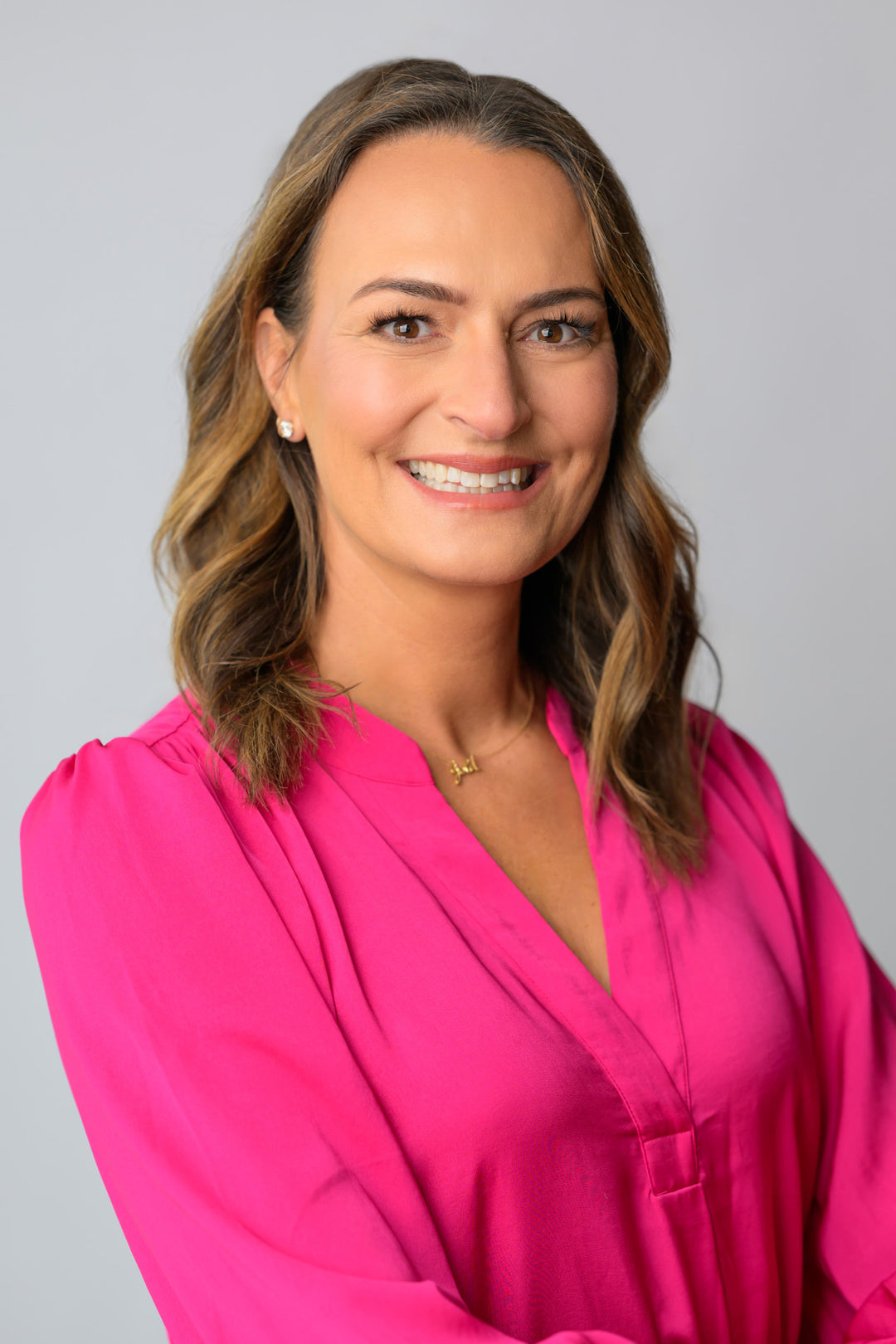 Dr. Milica McDowell smiling in a pink blouse.